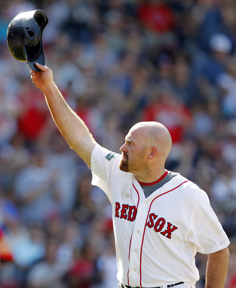 Kevin Youkilis acknowledges fans at Fenway Park as he leaves the field for the final time as a Red Sox. Youkilis got a standing ovation after leaving for a pinch runner in the seventh inning.