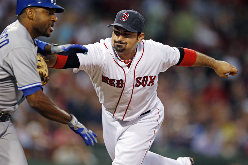 Adrian Gonzalez tags out Toronto’s Ben Francisco after a ground ball to first base Monday at Fenway Park. The Red Sox lost, 9-6, in a game delayed by rain for nearly two hours.