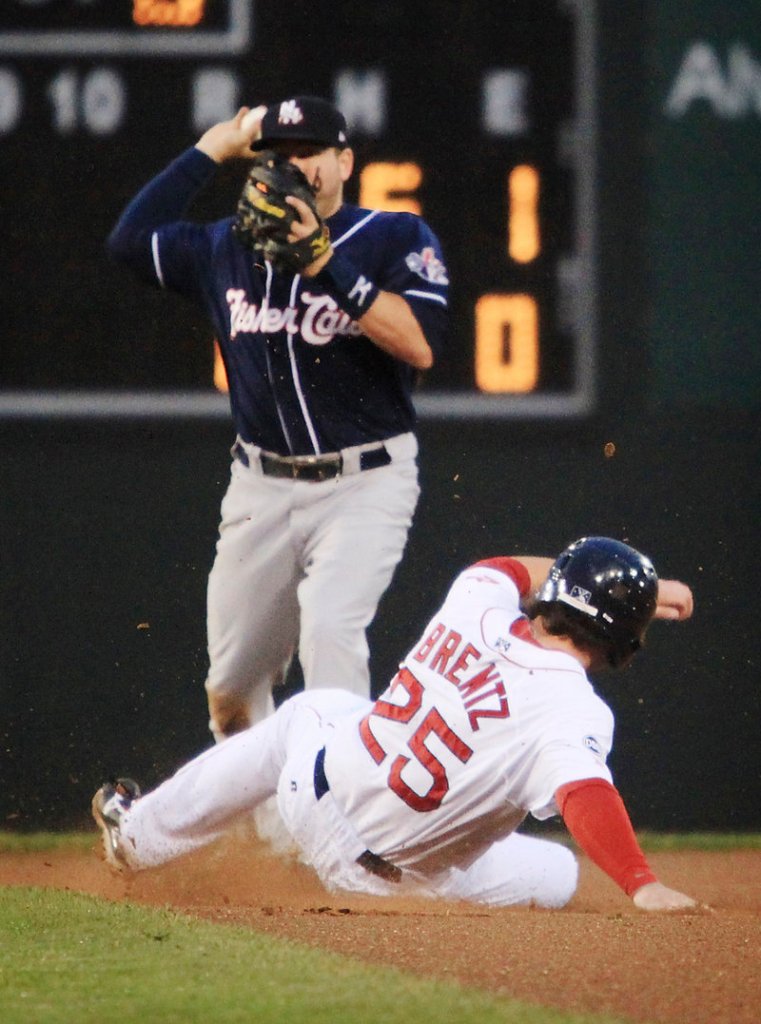Bryce Brentz of the Sea Dogs makes a tough slide but Brian Bocock of the Fisher Cats is able to get off a throw to complete a double play.