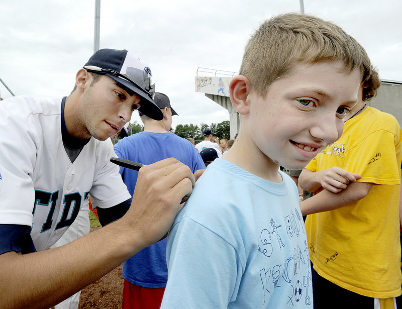 Sam Balzano, a Portland native, and the rest of the Raging Tide are happy to sign autographs – even on an ear lobe – including this one for 10-year-old Dylan Roberts of Steep Falls.