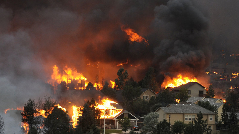 An entire neighborhood burns out of control near the foothills of Colorado Springs, Colo. in a photo taken Tuesday.
