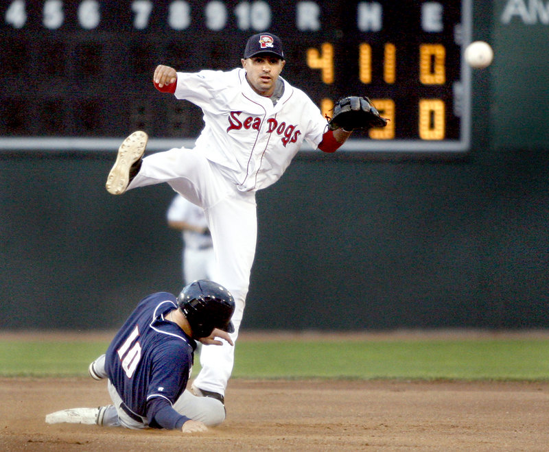 Ryan Dent of the Portland Sea Dogs avoids a slide by Brian Bocock of the New Hampshire Fisher Cats while turning a double play Wednesday night in the fourth inning of New Hampshire’s 6-3 victory at Hadlock Field.
