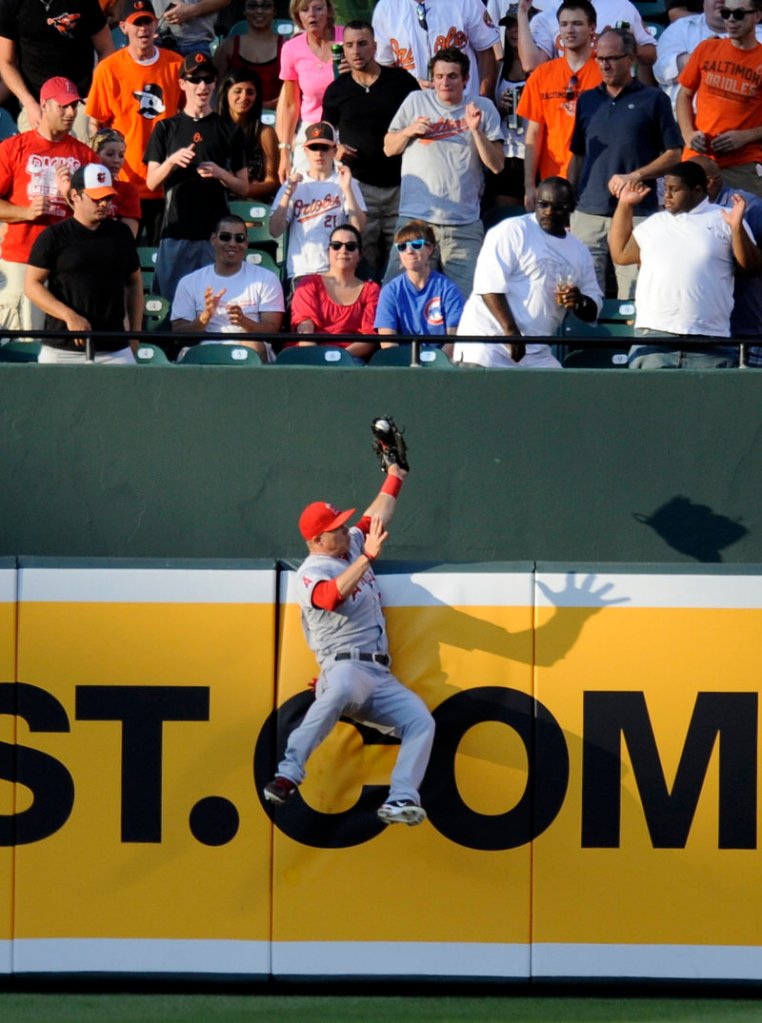 Mike Trout of the Los Angeles Angels robs J.J. Hardy of the Baltimore Orioles of extra bases during the first inning of the Angels’ 13-1 victory at Baltimore Wednesday night.