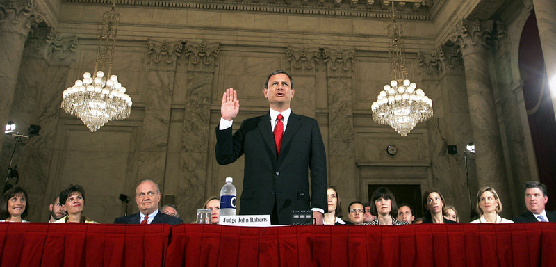Judge John G. Roberts raises his right hand as he is sworn in before the Senate Judiciary Committe to testify on his confirmation to become the chief justice of the United States, in the Senate’s Russell office building on Sept. 12, 2005.
