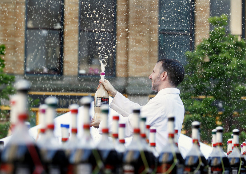 EepyBird co-founder Fritz Grobe of Buckfield is drenched in soda during the EepyBird Coke and Mentos Spectacular in Monument Square Thursday evening.