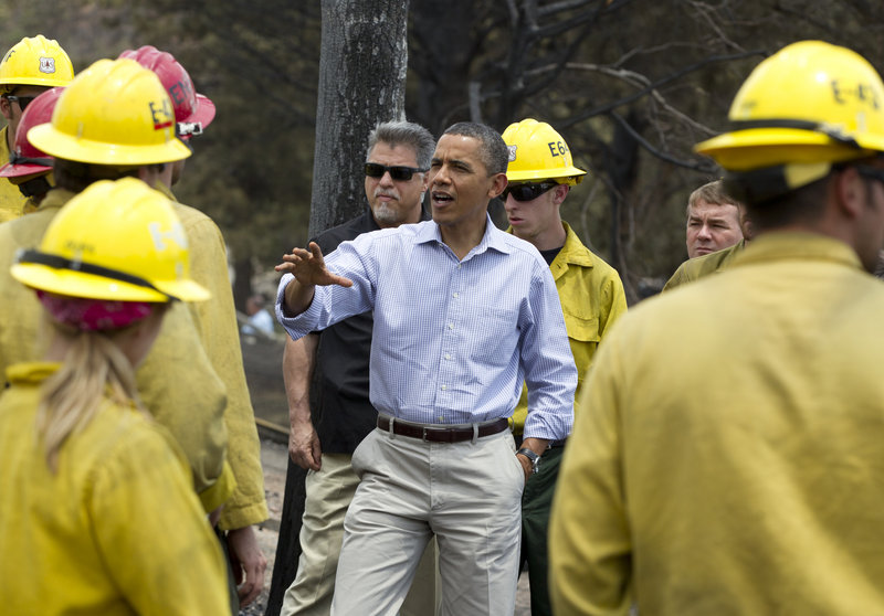 President Obama talks with firefighters on Friday in a neighborhood of Colorado Springs, Colo. “The country is grateful for your work. The country’s got your back,” he said.