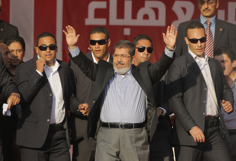 Egypt’s President-elect Mohammed Morsi waves to tens of thousands of mostly Islamist supporters at Tahrir Square, the focal point of the Egyptian uprising, in Cairo on Friday.