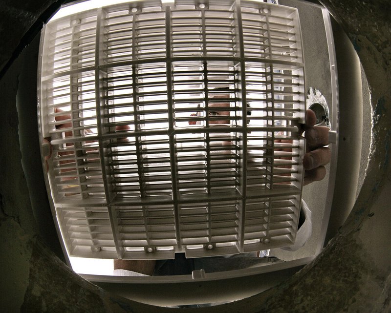 A pool serviceman checks the fit of a pool drain cover intended to prevent suction accidents in a photo taken in Miami shortly after the Virginia Graeme Baker Pool and Spa Safety Act went into effect in late 2008.