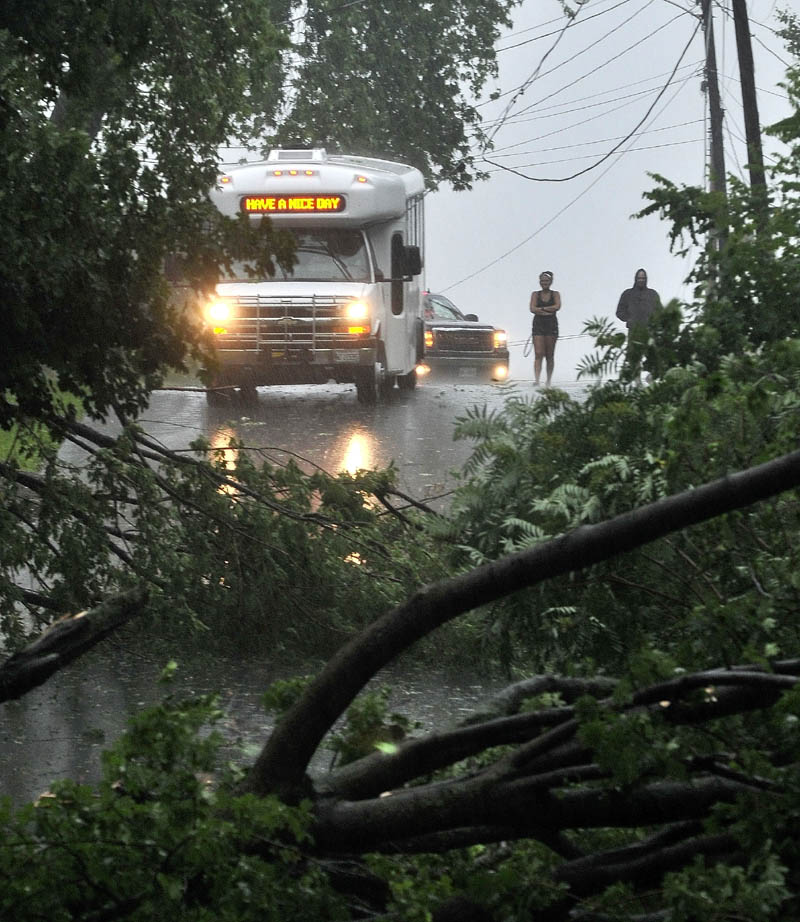 A Kennebec Valley Community Action Program bus was trapped by fallen power lines and a downed tree on Abbott Street in Waterville during the storm Friday.