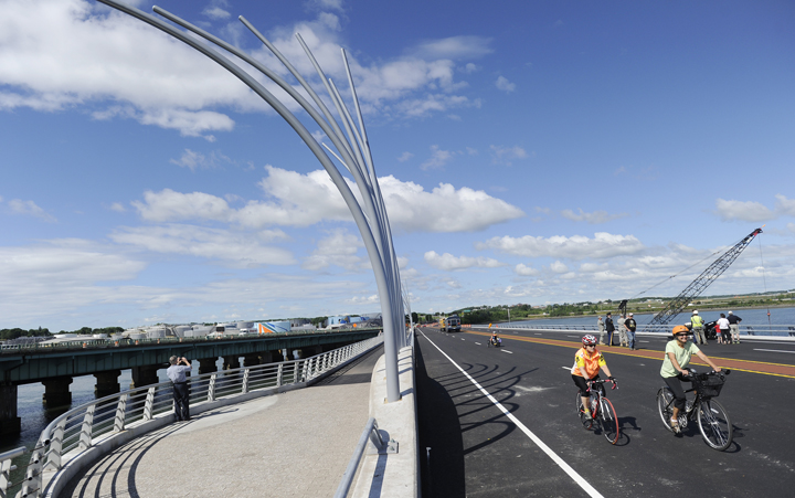 Cyclists make their way across Veterans Memorial Bridge before the opening ceremony this morning.