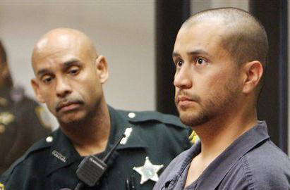 George Zimmerman, right, charged with killing 17-year-old Trayvon Martin, stands next to a Seminole County Deputy during a court hearing in Sanford, Fla., in this April 12, 2012, photo,