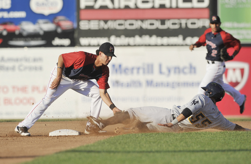 Derrik Gibson, the shortstop for the Portland Sea Dogs, slaps a tag on Trenton’s Jose Gil, who was attempting to steal second base Saturday night. Gil was called safe on the play.
