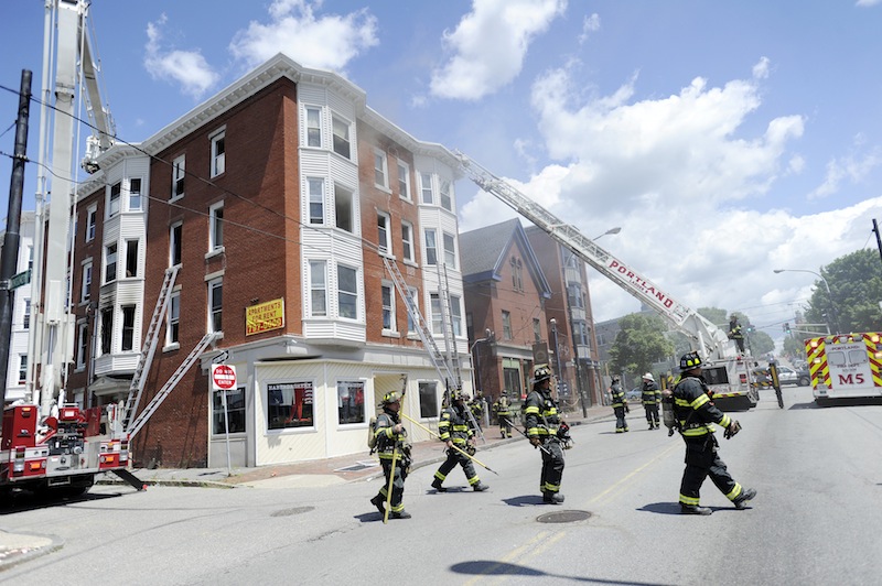 The fire department battles a fire at 229 Congress Street and 8 Montgomery Street in Portland on Monday, July 2, 2012.