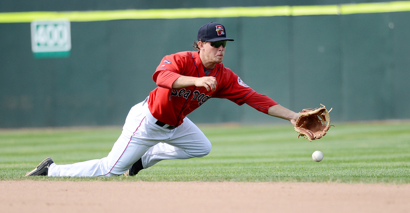 Zach Gentile of the Sea Dogs reaches for a hard-hit grounder in Sunday’s game at Hadlock Field. The ball went through to the outfield for a New Hampshire hit.