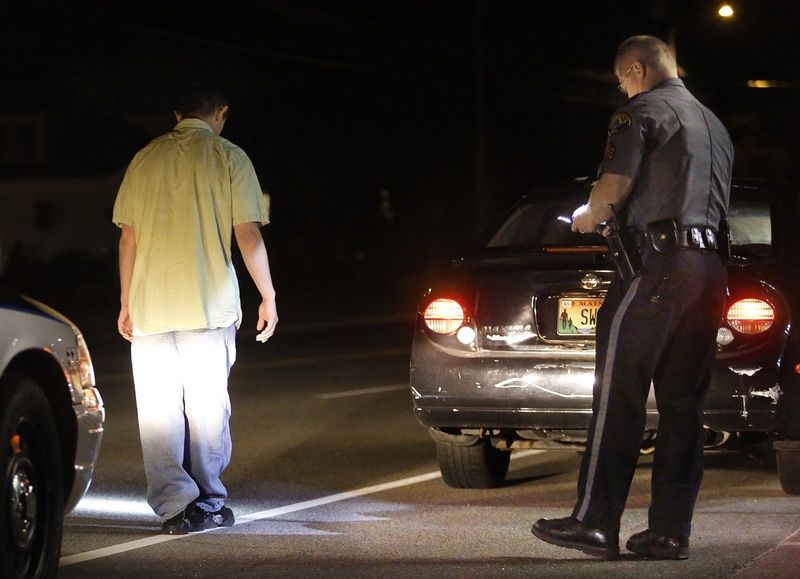 Scarborough police Sgt. Tom Chard conducts a sobriety test Thursday after stopping a motorist during an operating-under-the-influence detail on Route 1. The driver passed the test. Average conviction rates on OUI charges range from 37 percent in York County to 83 percent in Hancock and Penobscot counties.