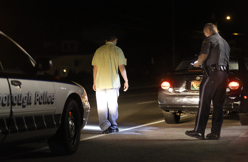 Scarborough police Sgt. Tom Chard conducts a sobriety test on a driver on Route 1 in Scarborough this month. The man passed the sobriety test. It's clear that higher-volume prosecutors’ offices are prioritizing their caseloads and allowing some OUI defendants to plead to lesser charges.