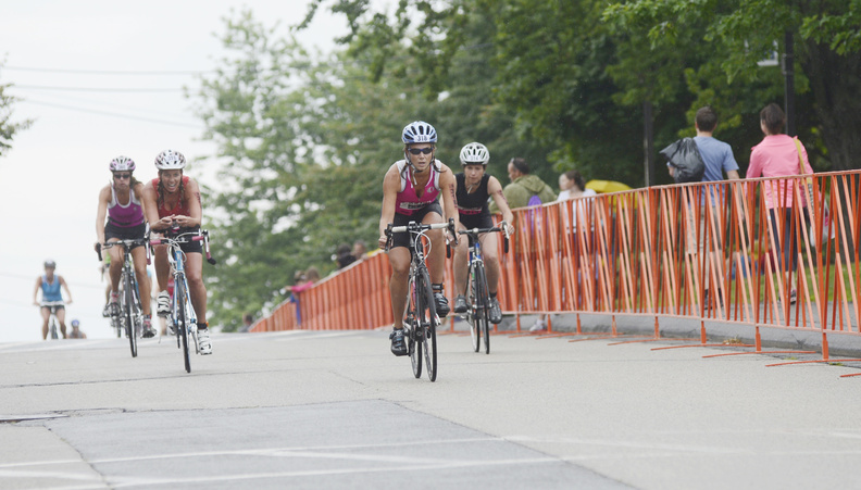 Tri for a Cure participants make their way down Fort Road during the bicycle portion of the event Sunday.
