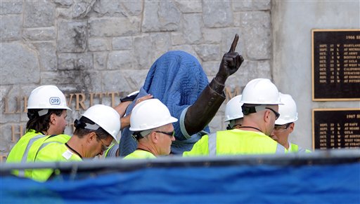Workers from the Penn State Office of Physical Plant cover the statue of former football coach Joe Paterno near Beaver Stadium in State College, Pa., on Sunday prior to the statue's removal.