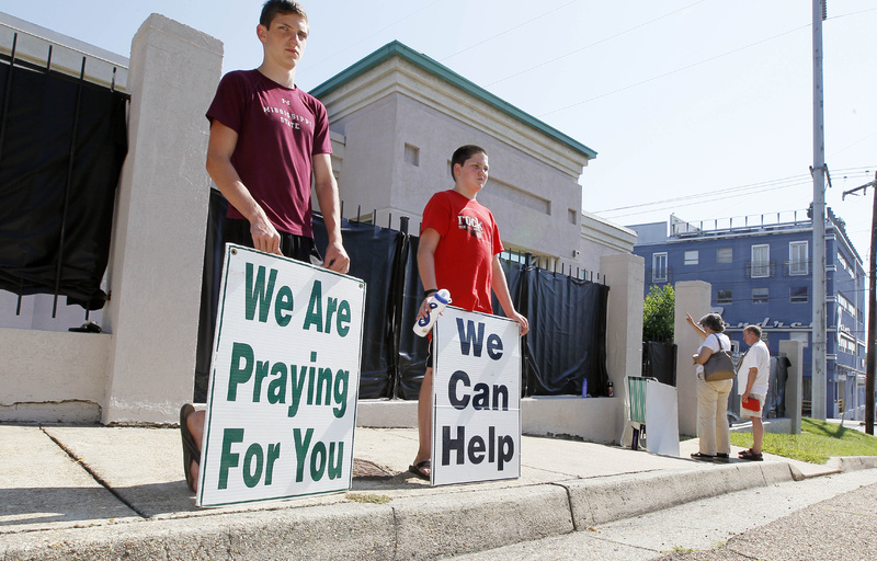 Opponents of abortion stand outside Mississippi's only abortion clinic, singing and praying for their patients, and "counseling" them to reject abortion.