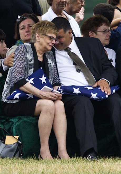 Barbara Annechino is comforted by her brother Jeffrey Christiano during the burial service for their father Air Force Col. Joseph Christiano, and Col. Derrell B. Jeffords, Lt. Col. Dennis L. Eilers, Chieft Master Sgt. William K. Colwell, Chief Master Sgt. Arden K. Hassenger and Chief Master Sgt. Larry C. Thornton, Monday, July 9, 2012, at Arlington National Cemetery Arlington, Va. It was Christmas Eve 1965 when the Air Force plane nicknamed "Spooky" took off from Vietnam for a combat mission. The crew sent out a "mayday" signal while flying over Laos, and after that, all contact was lost. Two days of searches turned up nothing. (AP Photo/Haraz N. Ghanbari)