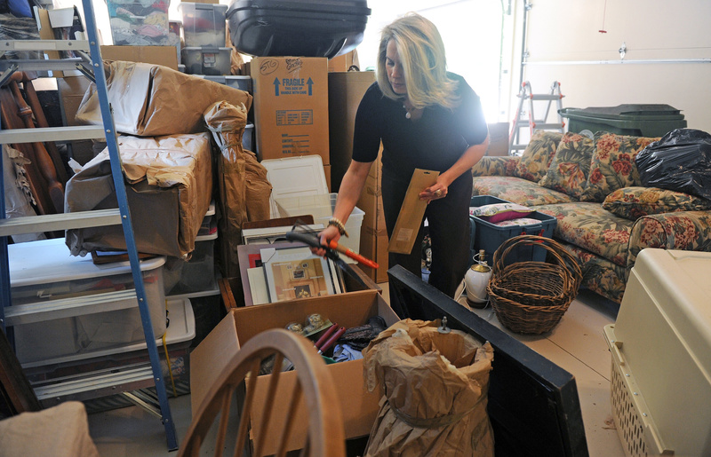 Certified professional organizer Sara Fisher goes through items brought over from a storage space at a client’s home in Atlanta, Ga. The trend of offering services to people who can’t or don’t want to do them is growing. 04000000 FIN krtbusiness business krtnational national krtedonly cdm mct 04006000 krtfinancialservice financial services krtnamer north america krtusbusiness u.s. us united states 2012 krt2012