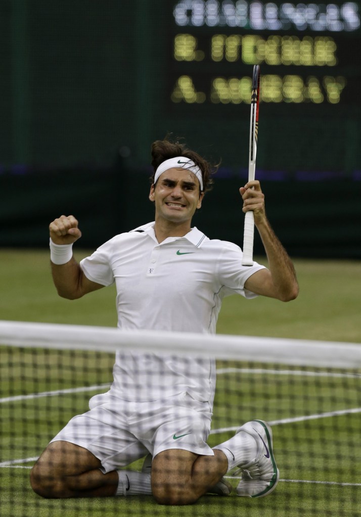 Roger Federer of Switzerland celebrates winning the men's singles final against Andy Murray of Britain at the All England Lawn Tennis Championships at Wimbledon, England, Sunday.