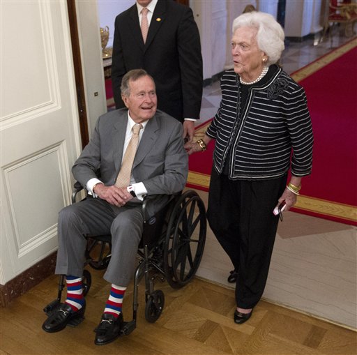 Former President George H.W. Bush and former first lady Barbara Bush arrive in the East Room of the White House in Washington on May 31 for a ceremony to unveil the official portrait of their son former President George W. Bush. Bush and his wife Barbara won't be attending the Republican National Convention next month in Tampa because of health reasons. (AP Photo/Pablo Martinez Monsivais)