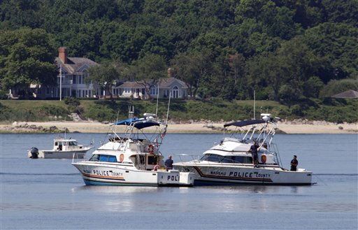 Two Nassau County police boats are stationed near the opening to the Long Island Sound in Lloyd Harbor, N.Y., today. Investigators are trying to learn more about the crucial seconds before a yacht capsized off Long Island, killing three children and leaving 24 others scrambling for their lives. Efforts to raise the boat might begin as early as Friday. (AP Photo/Richard Drew)