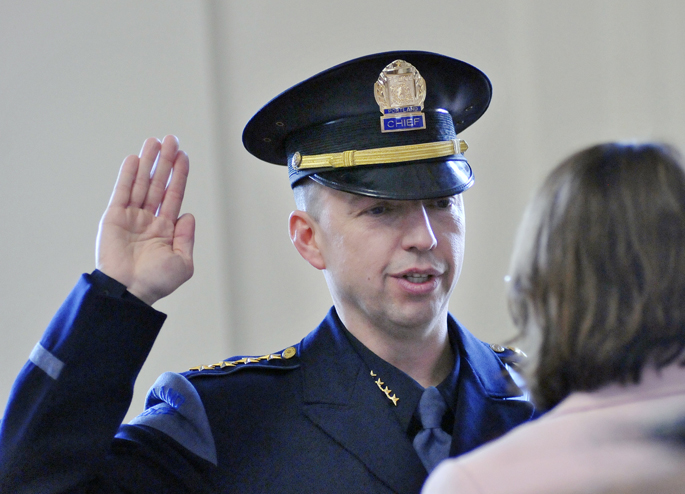 Michael Sauschuck is sworn in by city clerk Katherine Jones as Portland's Police Chief on Monday, March 5, 2012 at City Hall. Sauschuck will soon begin 10 weeks of training at the FBI's National Academy in Quantico, Virginia.