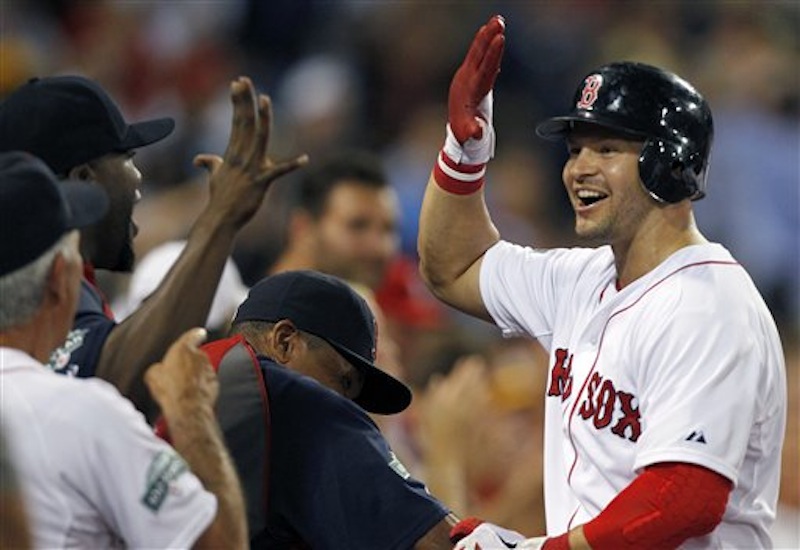 Boston Red Sox's Cody Ross, right, celebrates his three-run home run in the fourth inning of a baseball game against the Chicago White Sox in Boston, Wednesday, July 18, 2012. (AP Photo/Michael Dwyer)