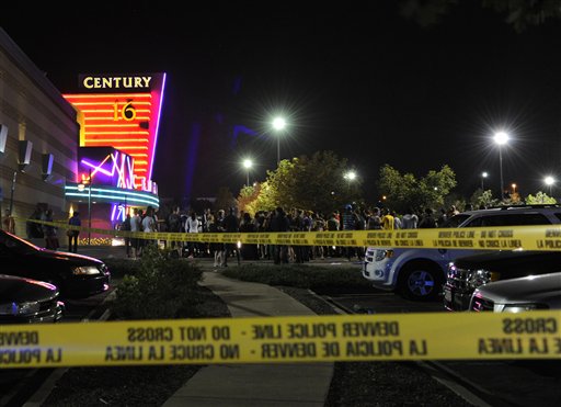 People gather outside the Century 16 movie theater in Aurora, Colo., at the scene of a mass shooting early this morning. Police say 12 people are dead following the shooting at the suburban Denver theater.
