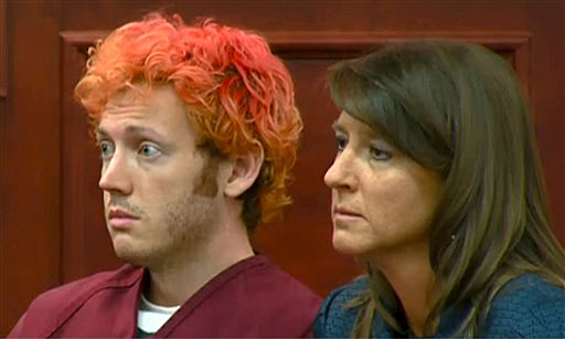 In this image taken from video provided by KUSA.com, James E. Holmes, left, makes his first appearance in court with his attorney Tamara Brady in Centennial, Colo. today.