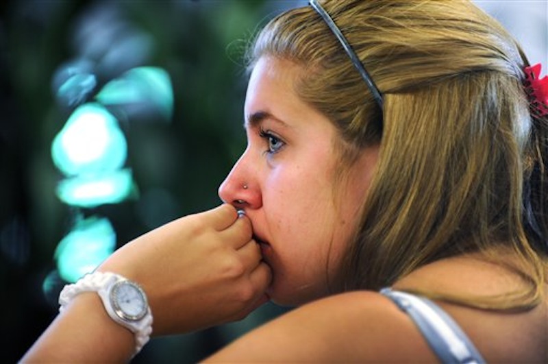 Penn State student Jessica Knoll begins to cry as she watches the televised news conference held by former FBI director Louis Freeh after the release of his report on the Jerry Sandusky child sex abuse scandal in the HUB building on the main campus in State College, Pa., Thursday, July 12, 2012. Freeh's investigation found that senior Penn State officials, including Hall of Fame football coach Joe Paterno, "concealed critical facts" about Jerry Sandusky's child abuse because they were worried about bad publicity. (AP Photo/Centre Daily Times, Nabil K. Mark)