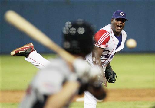 Cuban player Yadier Pedroso throws during a baseball game between a team of collegiate stars representing the United States and a veteran Cuban national squad in Havana, Cuba, on Thursday.