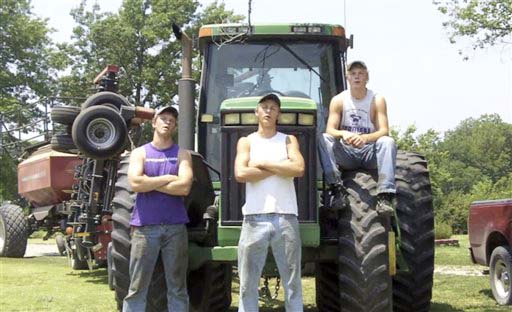 This frame grab from video shows Assaria, Kan., brothers, from left: Nathan; Greg and Kendal Peterson in their video parody on LMAFO's "Sexy and I Know It." The parody, that has gone viral on YouTube and Facebook, shows the three brothers rapping their farming mission on the family's Saline County farm. (AP Photo/Courtesy Greg Peterson)
