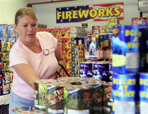Sheila Grimes of South Berwick, Maine, looks through piles of fireworks at Hilltop Fireworks on Tuesday in Somersworth, N.H.