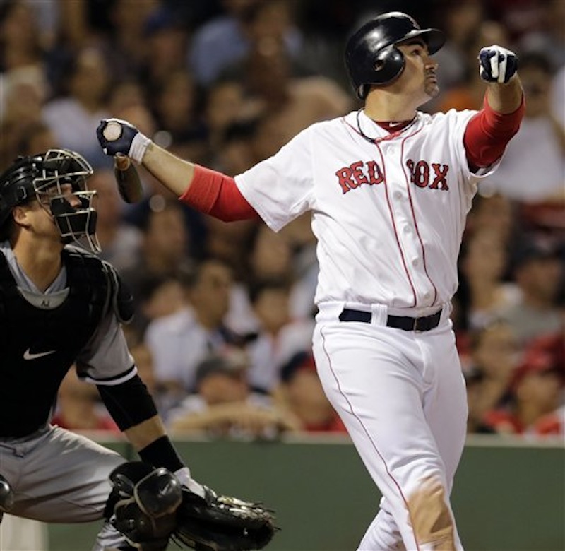 Boston Red Sox's Adrian Gonzalez watches the flight of his three-run homer in the eighth inning against the Chicago White Sox at Fenway Park in Boston on Monday. At left is White Sox catcher A.J. Pierzynski.