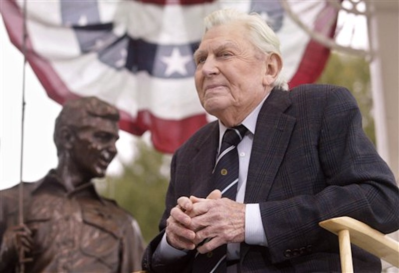 This Oct. 28, 2003 file photo shows actor Andy Griffith sitting in front of a bronze statue of Andy and Opie from the "Andy Griffith Show," after the unveiling ceremony in Raleigh, N.C. Griffith, whose homespun mix of humor and wisdom made "The Andy Griffith Show" an enduring TV favorite, died Tuesday, July 3, 2012 in Manteo, N.C. He was 86. (AP Photo/Bob Jordan, File)