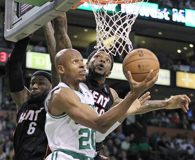 Former Boston Celtics guard Ray Allen drives past Miami Heat forward LeBron James and forward Udonis Haslem during Game 3 of the NBA playoffs Eastern Conference finals in Boston on June 1, 2012.