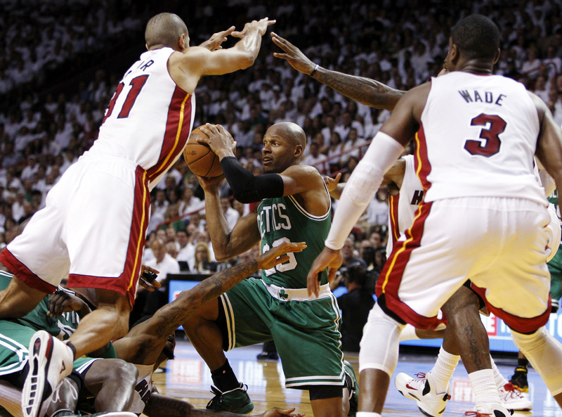 In this June 5 file photo, Ray Allen of the Boston Celtics looks to pass the ball as Miami Heat's Shane Battier (31) and Dwyane Wade (3) defend. Allen told the Heat tonight that he has decided to leave the Celtics and join the reigning NBA champions.