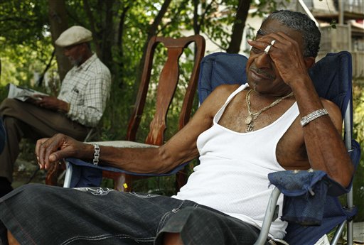 Men who identified themselves as Papa B, left, and Cadillac Bob, find refuge from the heat in a shaded lot between their homes on Thursday on Chicago's south side. Chicago hit 103 degrees.