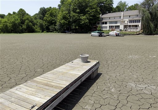 A dock extends into a dry cove at Morse Reservoir in Noblesville, in central Indiana, where temperatures exceeded 100 degrees Thursday. The reservoir is down 3.5 feet from normal levels.