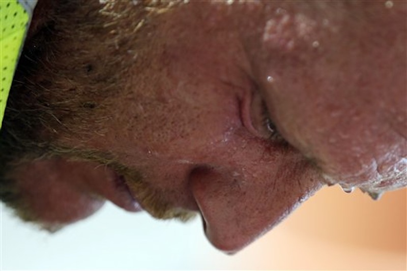 Perspiration collects on construction worker David Macmullen's face in the afternoon heat, Friday, July 6, 2012, in Philadelphia. The National Weather Service said the record-breaking heat that has baked the nation's midsection for several days was slowly moving into the mid-Atlantic states and Northeast. Excessive-heat warnings remained in place Friday for all of Iowa, Indiana and Illinois as well as much of Wisconsin, Michigan, Missouri, Ohio and Kentucky. (AP Photo/Matt Rourke)