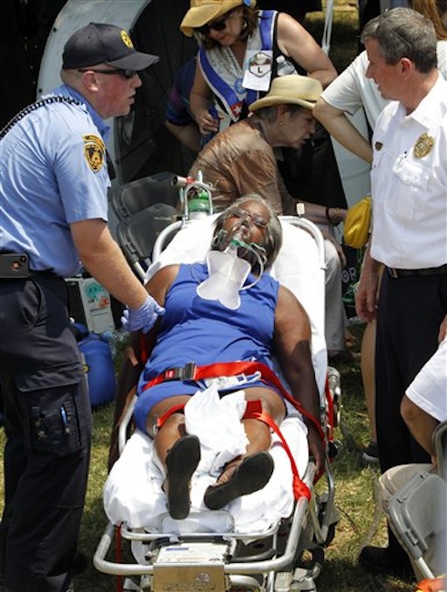 A woman is taken away on a stretcher after being effected by the heat while waiting for President Barack Obama at Carnegie Mellon University in Pittsburgh, Friday, July 6, 2012. Obama is on a two-day bus campaign trip through Ohio and Pennsylvania (AP Photo/Keith Srakocic)