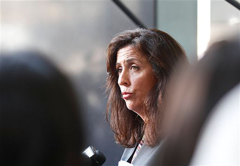 Lisa Damiani, an attorney and spokesperson for the parents of alleged Colorado mass murderer James Holmes, listens to a question during a news conference Monday, July 23, 2012 in San Diego. Damiani says Holmes' mother had no idea he was believed to be the gunman who killed a dozen people in a Colorado theater until a reporter contacted her at her San Diego home. (AP Photo/Lenny Ignelzi)