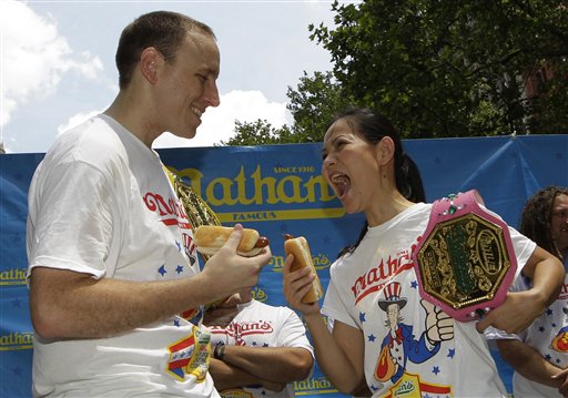Women's hot-dog eating record-holder, Sonya "The Black Widow" Thomas challenges five-time hot-dog eating world champion Joey Chestnut during a weigh-in for contestants in the annual Coney Island Fourth of July international hot-dog eating contest. The event takes place today at Coney Island in Brooklyn. Chestnut will try to break his own world record of downing 68 hot dogs and buns in 10 minutes. Thomas, who weighs 100 pounds, will headline the women's competition, facing 14 female eaters from the U.S. and Canada.
