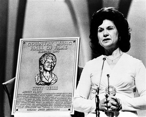 This 1976 file photo shows Country Music Hall of Fame inductee Kitty Wells during the Country Music Association (CMA) awards in Nashville, Tenn. Wells, the first female superstar of country music, has died at the age of 92. The singer's family says Wells died at her home Monday after complications from a stroke. Her recording of "It Wasn't God Who Made Honky Tonk Angels" in 1952 was the first No. 1 hit by a woman soloist on the country music charts. Other hits included "Making Believe" and a version of "I Can't Stop Loving You." (AP Photo, file)