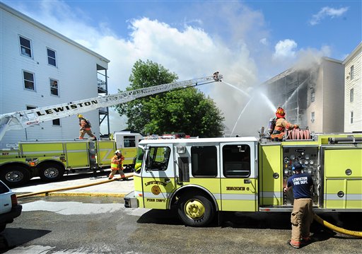 Lewiston and surrounding area fire departments battle a fire on Tuesday involving a 12-unit four-story apartment building, a one-and-a-half story single-family structure next door and a third building adjacent to it.
