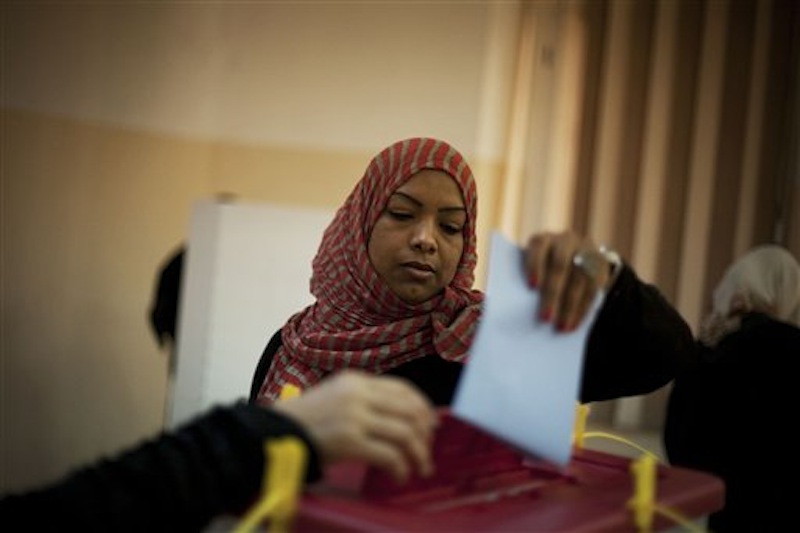 A Libyan woman votes at a polling station in the old city of Tripoli, Libya, Saturday, July 7, 2012. Jubilant Libyan voters marked a major step toward democracy after decades of erratic one-man rule, casting their ballots Saturday in the first parliamentary election after last year's overthrow and killing of longtime leader Moammar Gadhafi. But the joy was tempered by boycott calls, the burning of ballots and other violence in the country's restive east. (AP Photo/Manu Brabo)