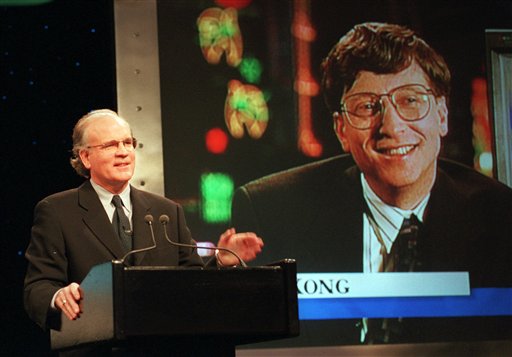 In this Dec. 14, 1995, file photo, Robert Wright, president and CEO of NBC, speaks in New York as Microsoft Chairman Bill Gates, displayed on screen, speaks from Hong Kong, during the announcement of the launch of MSNBC, a cable news channel and related online service. Microsoft is pulling out of the joint venture that owned MSNBC.com. The breakup, announced late today, dissolves the final shred of a 16-year marriage between Microsoft Corp. and NBC News, which is now owned by Comcast Corp.